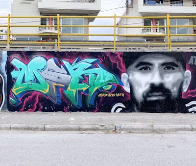 Colorful and Cyan and Grey Stylewriting by bzks and Merlin. This Graffiti is located in Thessaloniki, Greece and was created in 2023. This Graffiti can be described as Stylewriting, Characters and Wall of Fame.
