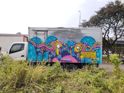 Cyan and Coralle and Yellow Characters by Rafia. This Graffiti is located in Depok, Indonesia and was created in 2023. This Graffiti can be described as Characters, Streetart and Cars.