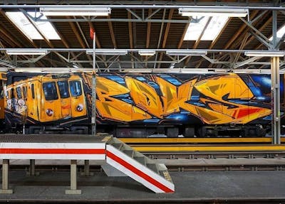 Orange Stylewriting by Damagers and boks. This Graffiti is located in Berlin, Germany and was created in 2020. This Graffiti can be described as Stylewriting, Characters, Trains and Wholecars.