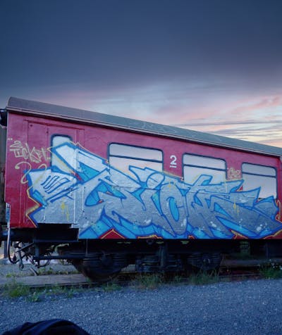 Chrome and Light Blue Stylewriting by Riots. This Graffiti is located in Jena, Germany and was created in 2022. This Graffiti can be described as Stylewriting, Trains, Freights and Wall of Fame.