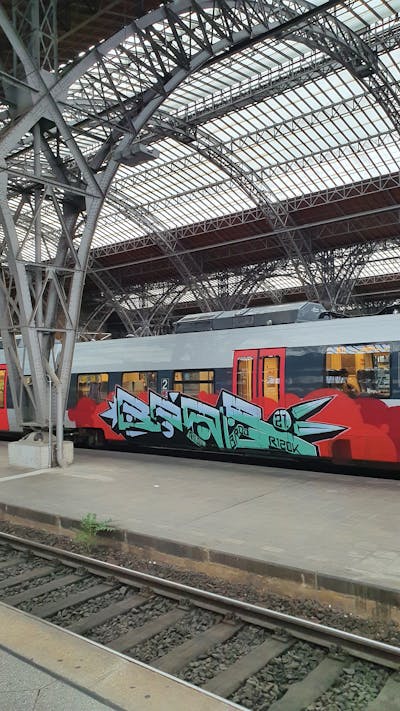 Cyan and Red Stylewriting by bros, rizok and R120K. This Graffiti is located in Leipzig, Germany and was created in 2021. This Graffiti can be described as Stylewriting and Trains.