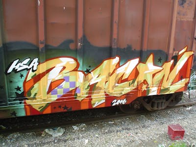 Red and Orange and Colorful Stylewriting by Bacon and exchange with House. This Graffiti is located in Toronto, Canada and was created in 2006. This Graffiti can be described as Stylewriting, Trains and Freights.