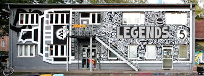 White and Grey Characters by Hülpman, AgeAge, Kobe, OST, PÜTK and nsc. This Graffiti is located in Potsdam, Germany and was created in 2020. This Graffiti can be described as Characters, Streetart and Murals.