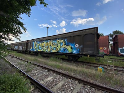 Beige and Light Blue Stylewriting by Poster. This Graffiti is located in HALLE, Germany and was created in 2021. This Graffiti can be described as Stylewriting and Trains.