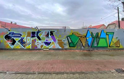Colorful Stylewriting by Cube Cuba and Royal Cru. This Graffiti is located in Uzhhorod, Ukraine and was created in 2022. This Graffiti can be described as Stylewriting and Street Bombing.