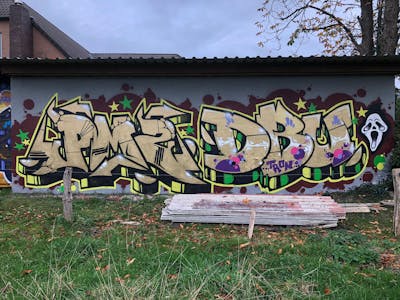 Gold and Yellow Stylewriting by ZICK, BERS and PMZ CREW. This Graffiti is located in Varel, Germany and was created in 2022. This Graffiti can be described as Stylewriting and Wall of Fame.