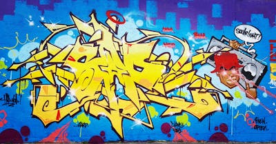 Yellow and Light Blue Stylewriting by SAO2971. This Graffiti is located in St helier, Jersey and was created in 2023. This Graffiti can be described as Stylewriting and Characters.