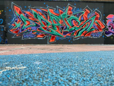 Cyan and Orange and Violet Stylewriting by Chips and CDSK. This Graffiti is located in London, United Kingdom and was created in 2022. This Graffiti can be described as Stylewriting and Wall of Fame.