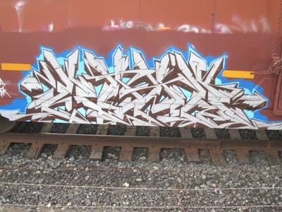 White and Brown and Light Blue Stylewriting by Kuhr. This Graffiti is located in United States and was created in 2023. This Graffiti can be described as Stylewriting, Trains and Freights.