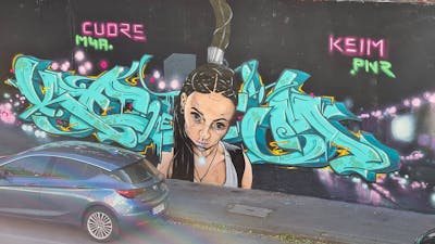 Cyan Stylewriting by CUORE and Keim. This Graffiti is located in Würzburg, Germany and was created in 2020. This Graffiti can be described as Stylewriting, Characters and Wall of Fame.