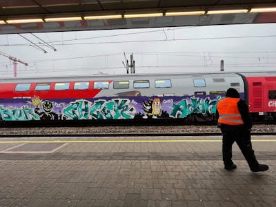 Violet and Cyan Trains by Check91_. This Graffiti is located in Comuna 13, Colombia and was created in 2022. This Graffiti can be described as Trains, Stylewriting and Characters.
