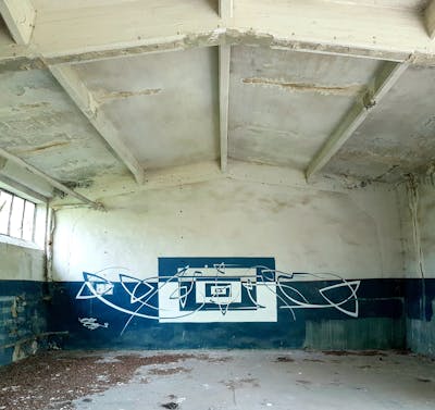 White and Black Futuristic by urine and OST. This Graffiti is located in Zerbst, Germany and was created in 2020. This Graffiti can be described as Futuristic, Abandoned and Handstyles.
