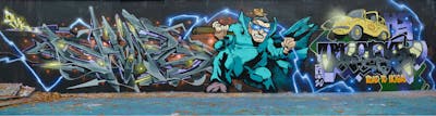 Grey and Cyan and Violet Stylewriting by Sorez, Chips and Uroki. This Graffiti is located in London, United Kingdom and was created in 2021. This Graffiti can be described as Stylewriting, Characters and Wall of Fame.