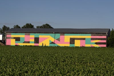 Yellow and Coralle and Cyan Roll Up by rizok, R120K and bros. This Graffiti is located in Leipzig, Germany and was created in 2012. This Graffiti can be described as Roll Up and Street Bombing.
