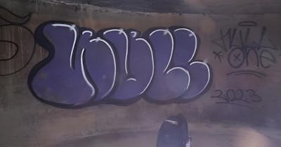Violet and Black Street Bombing by NULL. This Graffiti is located in Sândominic, Romania and was created in 2023. This Graffiti can be described as Street Bombing and Throw Up.