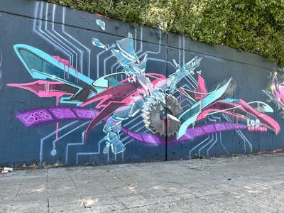 Cyan and Violet and Red Stylewriting by Syck, ABS, KKP and Los Capitanos. This Graffiti is located in Neuss, Germany and was created in 2023. This Graffiti can be described as Stylewriting and Characters.