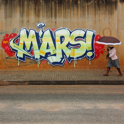 Blue and Light Green and Red Stylewriting by Mars. This Graffiti is located in Johannesburg, South Africa and was created in 2021. This Graffiti can be described as Stylewriting, Street Bombing and Atmosphere.