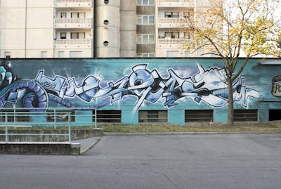 Cyan and Light Blue and White Stylewriting by SetteNoveUnoTre. This Graffiti is located in Brescia, Italy and was created in 2018.