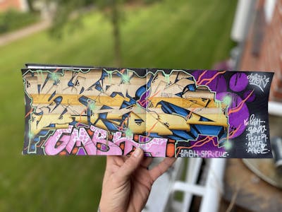 Colorful and Beige Blackbook by Srek. This Graffiti is located in Germany and was created in 2023. This Graffiti can be described as Blackbook.
