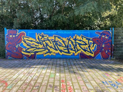 Blue and Yellow and Light Blue Stylewriting by Hülpman, OST, NBA, PÜTK and EineArt. This Graffiti is located in Berlin, Germany and was created in 2023. This Graffiti can be described as Stylewriting, Characters and Wall of Fame.