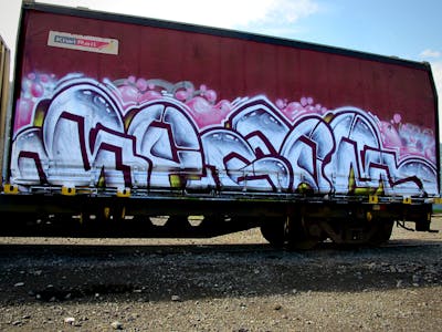 White and Colorful Stylewriting by Kezam. This Graffiti is located in Auckland, New Zealand and was created in 2022. This Graffiti can be described as Stylewriting, Trains and Freights.