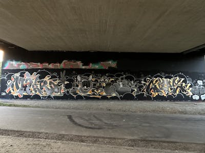 Black and Grey and Orange Stylewriting by Makro, Diro and Gaps. This Graffiti is located in Leipzig, Germany and was created in 2023. This Graffiti can be described as Stylewriting, Characters and Wall of Fame.