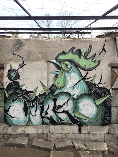 Cyan and Grey Characters by Tokk. This Graffiti is located in Geldern, Germany and was created in 2021. This Graffiti can be described as Characters and Abandoned.