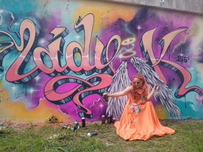 Coralle and Colorful Stylewriting by Lady.K and 156. This Graffiti was created in 2019 but its location is unknown. This Graffiti can be described as Stylewriting, Characters, Wall of Fame and Atmosphere.