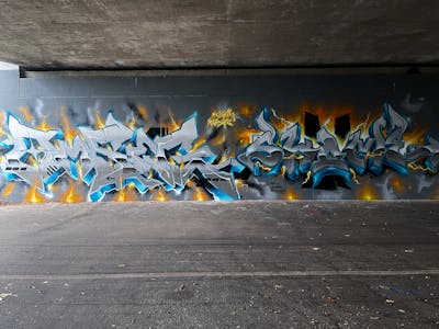 Grey and Light Blue Stylewriting by omseg and Kosem. This Graffiti is located in Freiburg, Germany and was created in 2022.