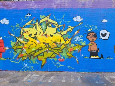 Yellow and Beige and Light Blue Stylewriting by SAO2971. This Graffiti is located in St helier, United Kingdom and was created in 2024. This Graffiti can be described as Stylewriting, Characters and Wall of Fame.