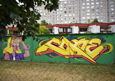 Yellow and Colorful Stylewriting by Coke and Suzie. This Graffiti is located in Budapest, Hungary and was created in 2022. This Graffiti can be described as Stylewriting and Characters.