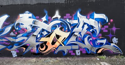 Chrome and Blue and Colorful Stylewriting by Toe One. This Graffiti is located in Frankfurt, Germany and was created in 2023.