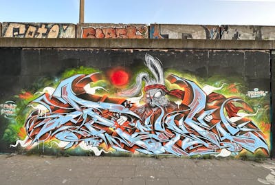 Light Blue and Colorful and Orange Stylewriting by Fresk. This Graffiti is located in Poznan, Poland and was created in 2023. This Graffiti can be described as Stylewriting, Characters, Streetart and Wall of Fame.