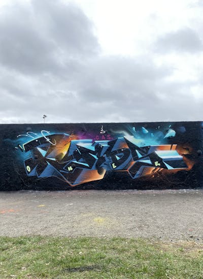 Light Blue and Black and Orange Stylewriting by Rymd. This Graffiti is located in Stockholm, Sweden and was created in 2024.