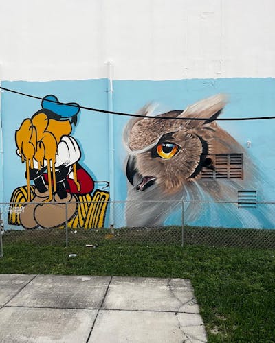 Colorful and Light Blue and Brown Characters by Someone and BustArt. This Graffiti is located in Miami, United States and was created in 2022. This Graffiti can be described as Characters and Streetart.