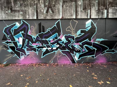 Cyan and Black Stylewriting by omseg. This Graffiti is located in Freiburg, Germany and was created in 2022. This Graffiti can be described as Stylewriting and Wall of Fame.