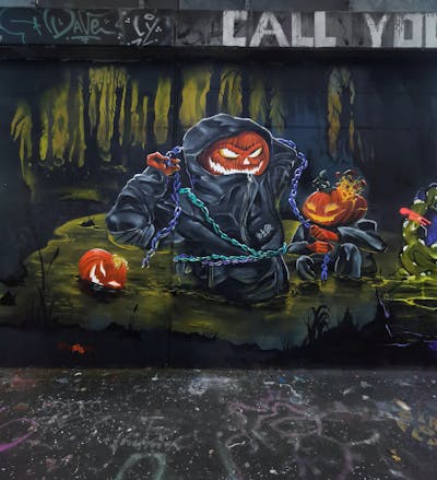 Orange and Colorful Characters by REVES ONE. This Graffiti is located in London, United Kingdom and was created in 2022. This Graffiti can be described as Characters and Wall of Fame.