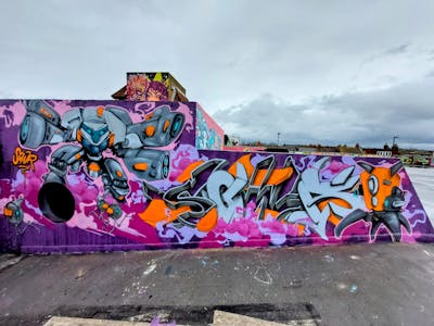 Violet and Grey and Orange Stylewriting by SQWR. This Graffiti is located in London, United Kingdom and was created in 2023. This Graffiti can be described as Stylewriting, Characters, Murals, Streetart and 3D.