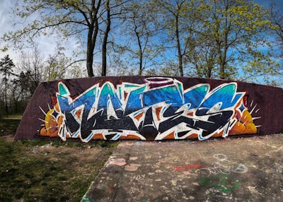 Blue and White and Orange Stylewriting by Notes, BTS and POK. This Graffiti is located in Prague, Czech Republic and was created in 2022. This Graffiti can be described as Stylewriting and Wall of Fame.