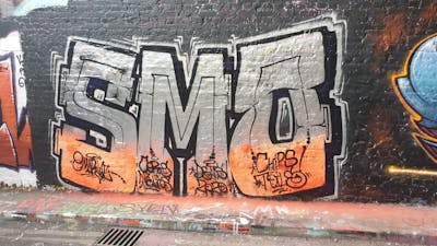 Orange and Chrome Stylewriting by smo__crew. This Graffiti is located in London, United Kingdom and was created in 2019. This Graffiti can be described as Stylewriting and Wall of Fame.