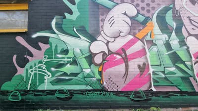 Coralle and Light Green and Green Handstyles by Pokar, Dizy and Graff.Funk. This Graffiti is located in Mainz, Germany and was created in 2023. This Graffiti can be described as Handstyles, Characters, Stylewriting and Wall of Fame.