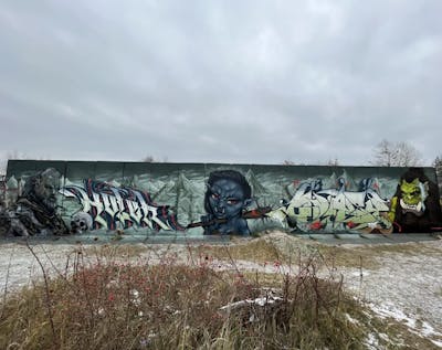 Grey and Light Green Stylewriting by AIDN, Holek, QUASI, CUORE and MAD. This Graffiti is located in Strausberg, Germany and was created in 2023. This Graffiti can be described as Stylewriting and Characters.