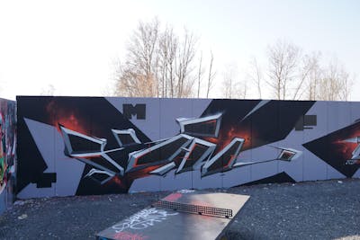 Grey and Black and Red Stylewriting by Kan. This Graffiti is located in Leipzig, Germany and was created in 2022. This Graffiti can be described as Stylewriting, Wall of Fame and Futuristic.