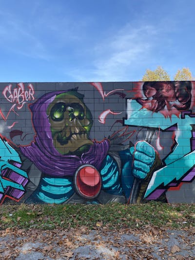 Colorful and Cyan Characters by Gaber. This Graffiti is located in Brescia, Italy and was created in 2022. This Graffiti can be described as Characters and Wall of Fame.