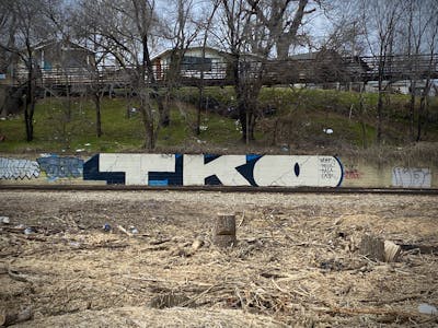 Beige and Black Stylewriting by Tko Crew. This Graffiti is located in Tulsa, United States and was created in 2024. This Graffiti can be described as Stylewriting and Line Bombing.