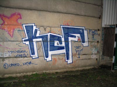 Blue and White Stylewriting by urine and KCF. This Graffiti is located in Magdeburg, Germany and was created in 2008. This Graffiti can be described as Stylewriting and Street Bombing.
