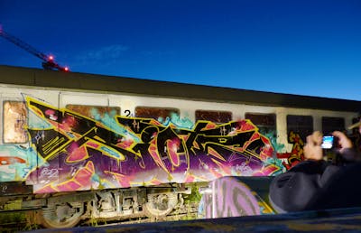 Colorful Stylewriting by Riots. This Graffiti is located in Jena, Germany and was created in 2022. This Graffiti can be described as Stylewriting, Trains, Freights, Atmosphere and Wall of Fame.