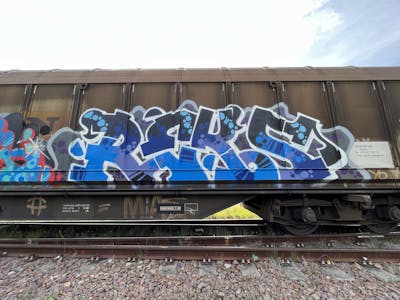Blue and Light Blue and Grey Stylewriting by REKS. This Graffiti is located in Italy and was created in 2023. This Graffiti can be described as Stylewriting, Trains and Freights.