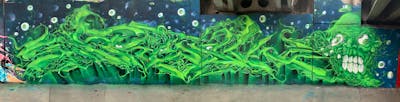 Light Green and Green Stylewriting by Fresk. This Graffiti is located in Poznan, Poland and was created in 2021. This Graffiti can be described as Stylewriting, Characters and Wall of Fame.