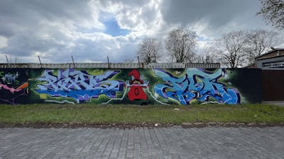 Light Blue and Light Green and Black Stylewriting by Picks and Thok. This Graffiti is located in Hettstedt, Germany and was created in 2023. This Graffiti can be described as Stylewriting and Characters.